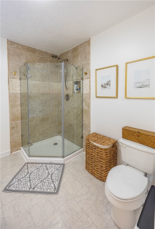 bathroom with a textured ceiling, toilet, and a shower with door