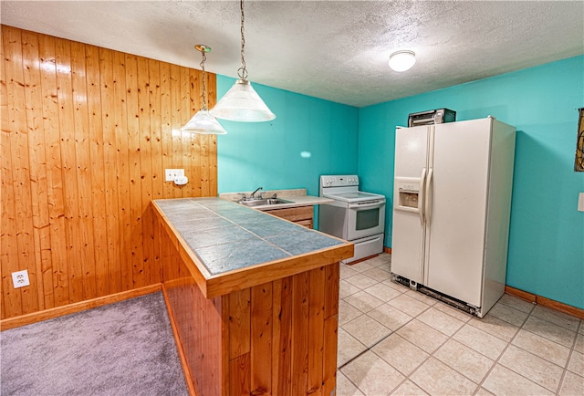 kitchen with white appliances, sink, hanging light fixtures, a textured ceiling, and kitchen peninsula