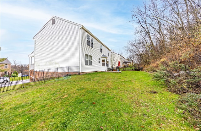 view of side of property with a lawn