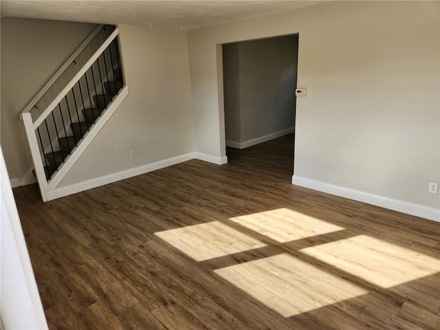 spare room with dark wood-type flooring