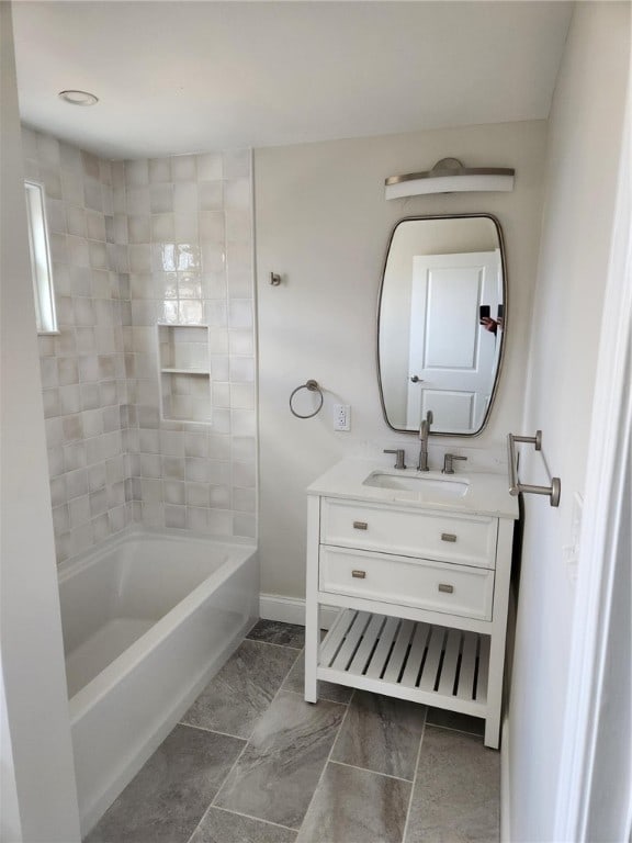 bathroom featuring vanity and tiled shower / bath