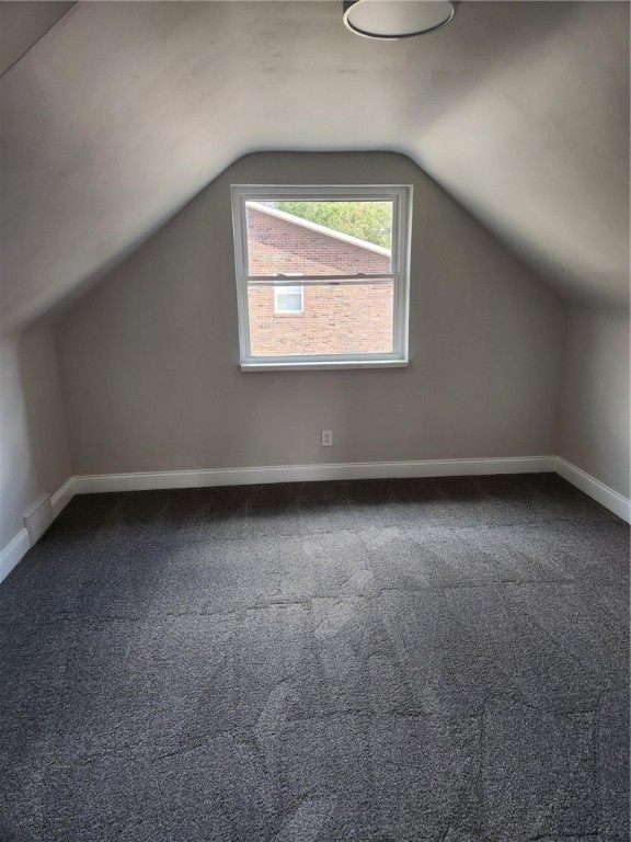 bonus room featuring carpet floors and lofted ceiling