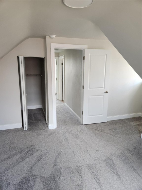 additional living space featuring light carpet and lofted ceiling