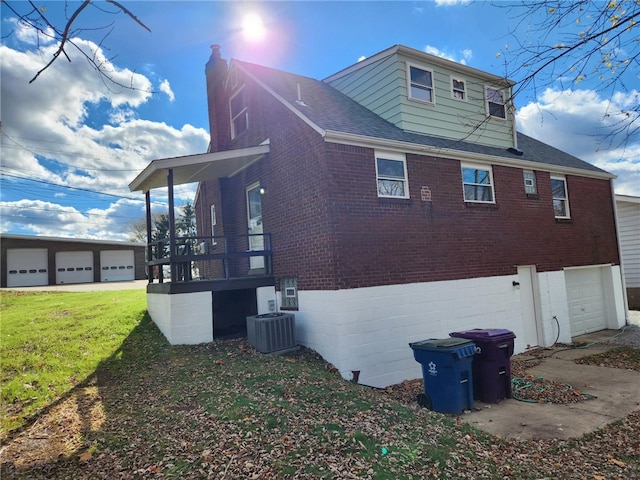 view of side of property with a lawn and a garage