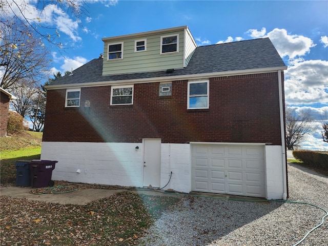 rear view of house with a garage