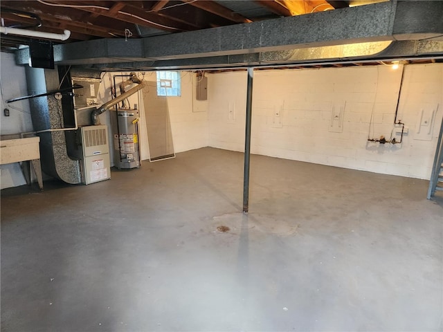 basement featuring gas water heater, electric panel, and heating unit