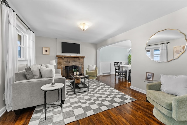 living room featuring a fireplace and dark hardwood / wood-style flooring