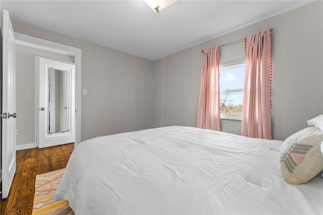 bedroom with dark hardwood / wood-style flooring