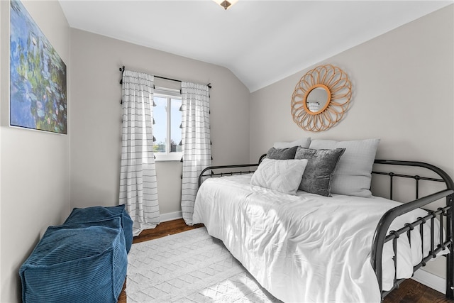 bedroom featuring wood-type flooring and lofted ceiling