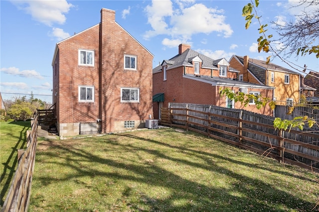 back of house featuring a yard