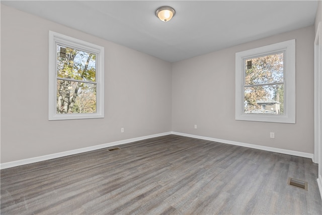 empty room with dark hardwood / wood-style flooring