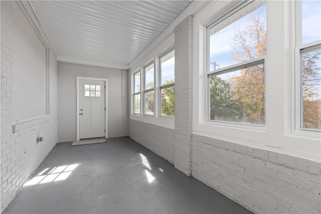 201 Conestoga Rd, Penn Hills, PA 15235 - unfurnished sunroom with finished concrete flooring and brick wall