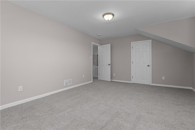 bonus room featuring carpet flooring and vaulted ceiling