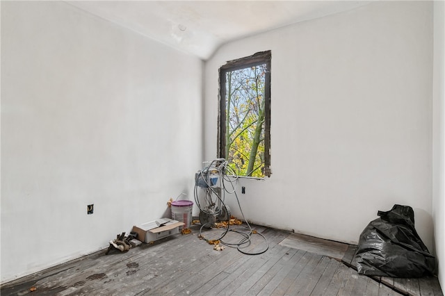 empty room featuring hardwood / wood-style flooring and lofted ceiling