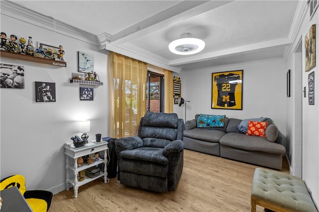 living room featuring light wood-type flooring, a textured ceiling, and ornamental molding