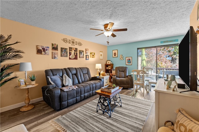 living room with hardwood / wood-style floors, a textured ceiling, and ceiling fan