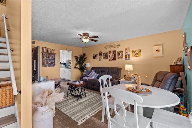 dining space with a textured ceiling, hardwood / wood-style flooring, and ceiling fan