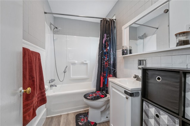 full bathroom with shower / bath combo, tasteful backsplash, vanity, wood-type flooring, and toilet