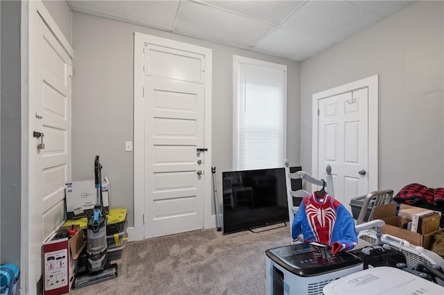 carpeted living room with a drop ceiling