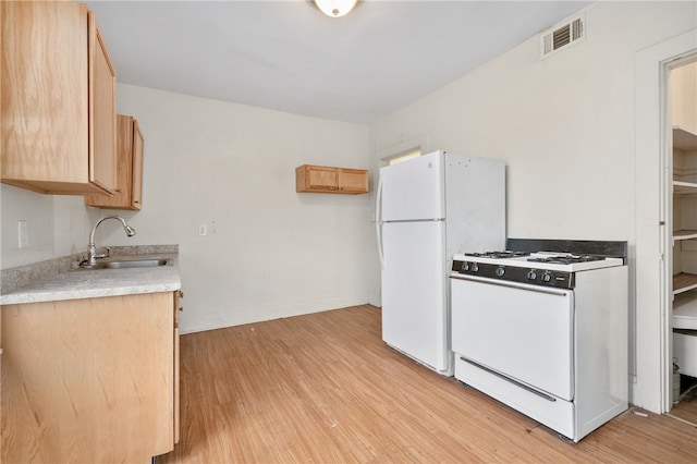 kitchen with light hardwood / wood-style floors, white appliances, sink, and light brown cabinets