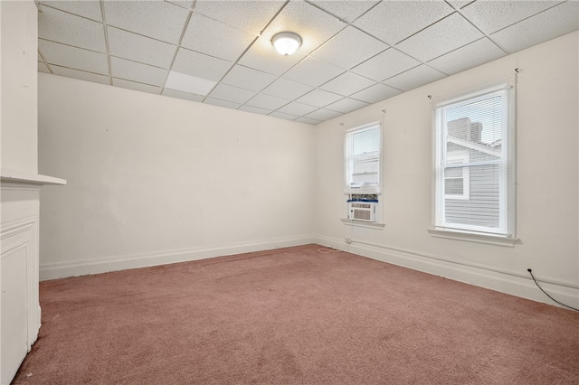 carpeted spare room with a drop ceiling