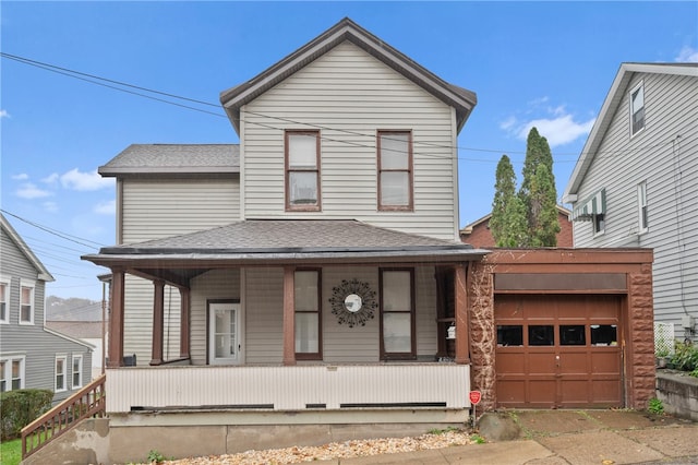 front of property featuring covered porch and a garage