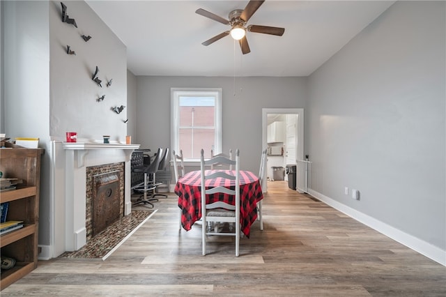 dining area with light hardwood / wood-style flooring and ceiling fan