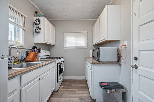 kitchen featuring white cabinets, white appliances, and crown molding