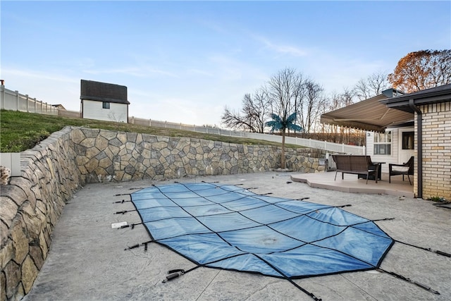 view of swimming pool featuring a patio area