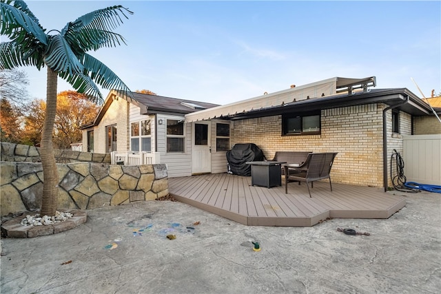 rear view of property featuring a deck