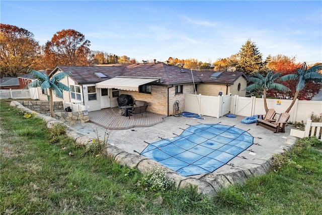 back of house featuring a patio and a pool side deck