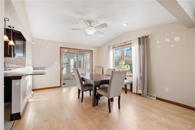 dining room featuring ceiling fan, light wood-type flooring, and lofted ceiling