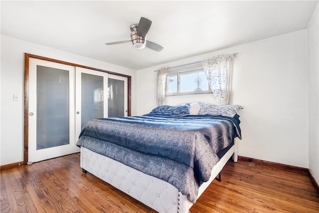 bedroom featuring ceiling fan, hardwood / wood-style floors, and french doors