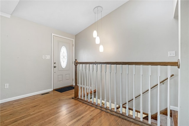 foyer entrance featuring hardwood / wood-style floors and lofted ceiling