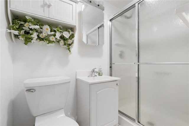 bathroom featuring vanity, toilet, and an enclosed shower