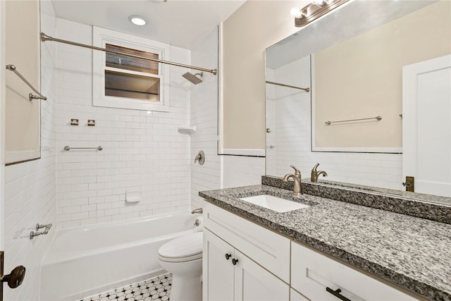 full bathroom featuring vanity, tile patterned flooring, tiled shower / bath combo, toilet, and tile walls