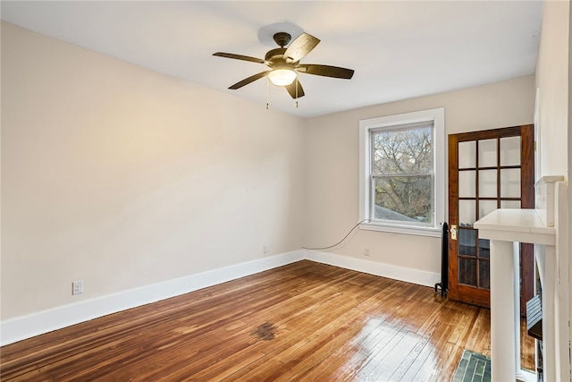 spare room with ceiling fan and hardwood / wood-style flooring