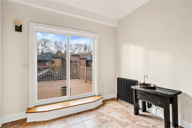 doorway to outside featuring radiator and light tile patterned floors