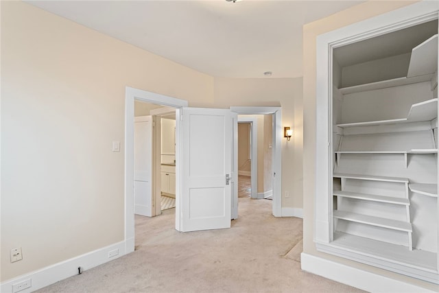 unfurnished bedroom with light colored carpet