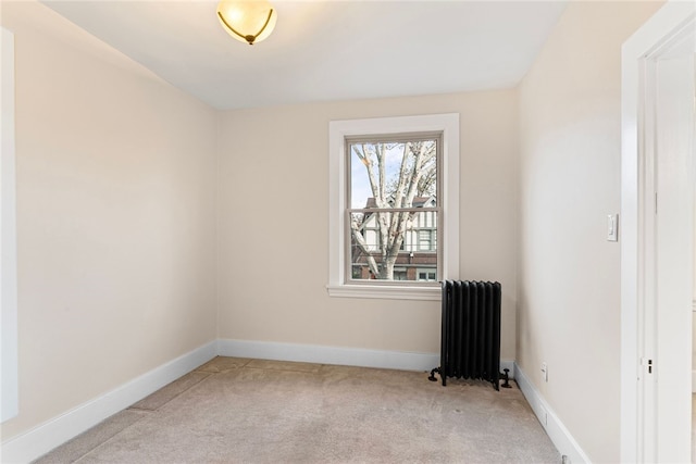 carpeted empty room with radiator