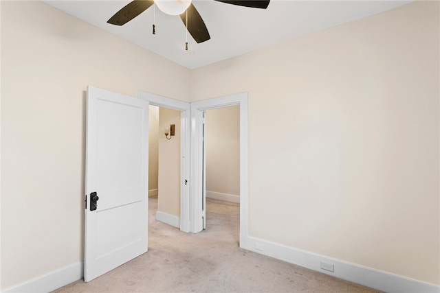 empty room with light colored carpet and ceiling fan