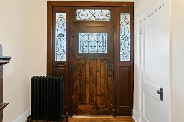 entrance foyer with hardwood / wood-style flooring and radiator