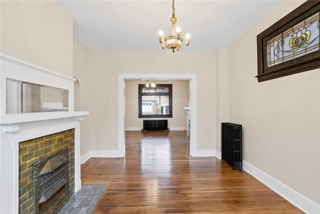 interior space featuring a notable chandelier, dark wood-type flooring, and radiator