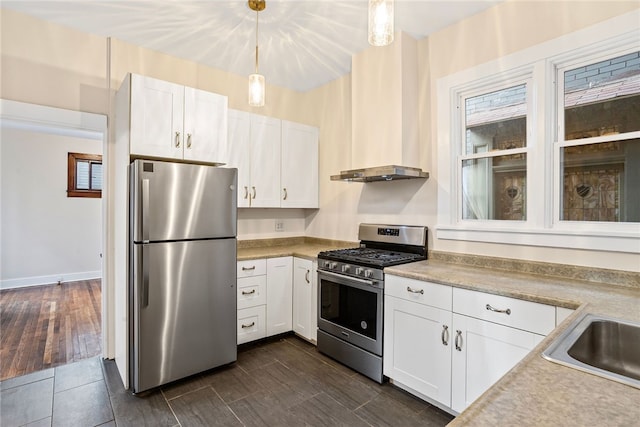 kitchen featuring decorative light fixtures, white cabinetry, stainless steel appliances, and dark wood-type flooring