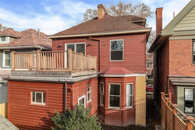 back of house with a balcony