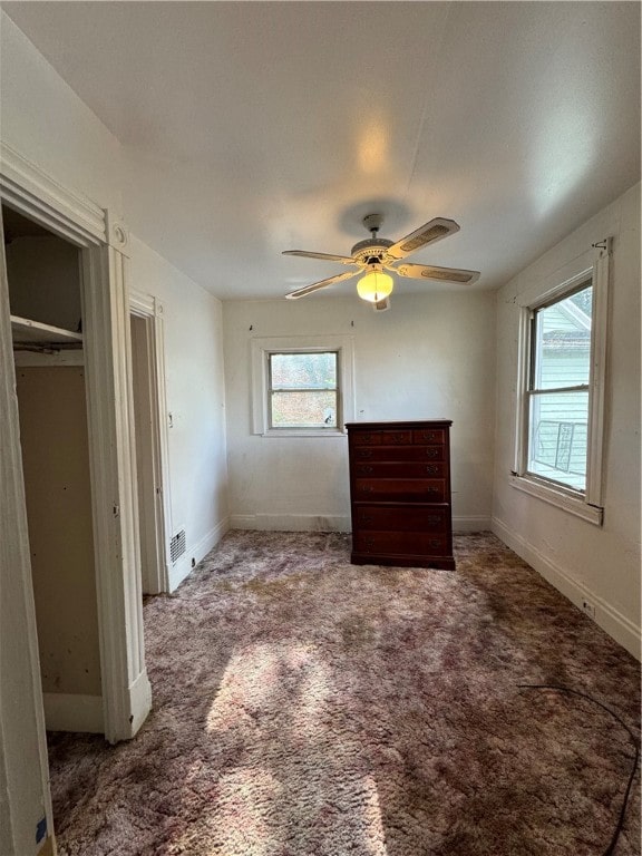 unfurnished bedroom with carpet flooring, ceiling fan, and a closet