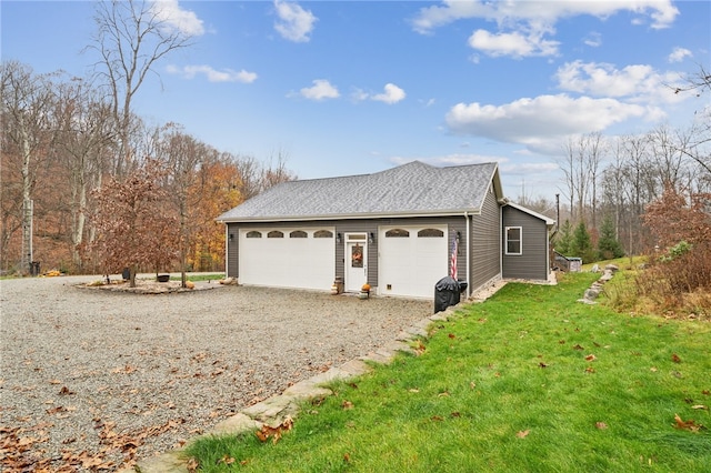 garage featuring a lawn