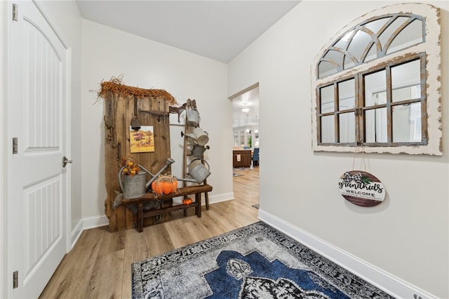 hallway with light hardwood / wood-style flooring