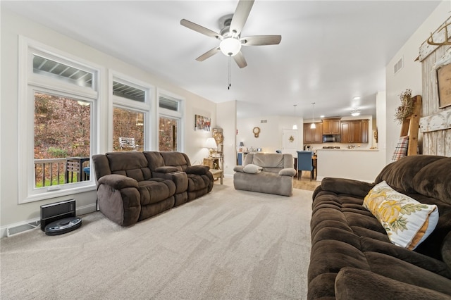 living room with carpet flooring and ceiling fan