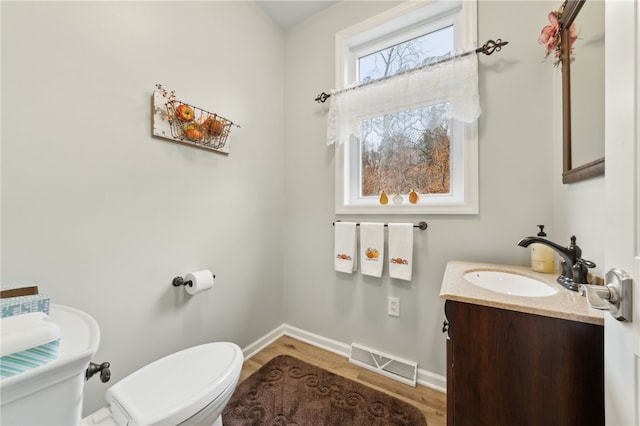 bathroom featuring hardwood / wood-style flooring, vanity, and toilet